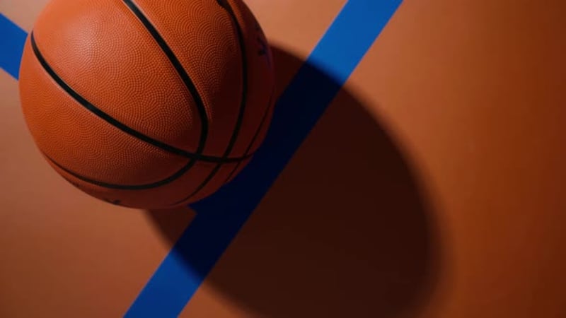 A Basketball Rolling on a Colorful Court
