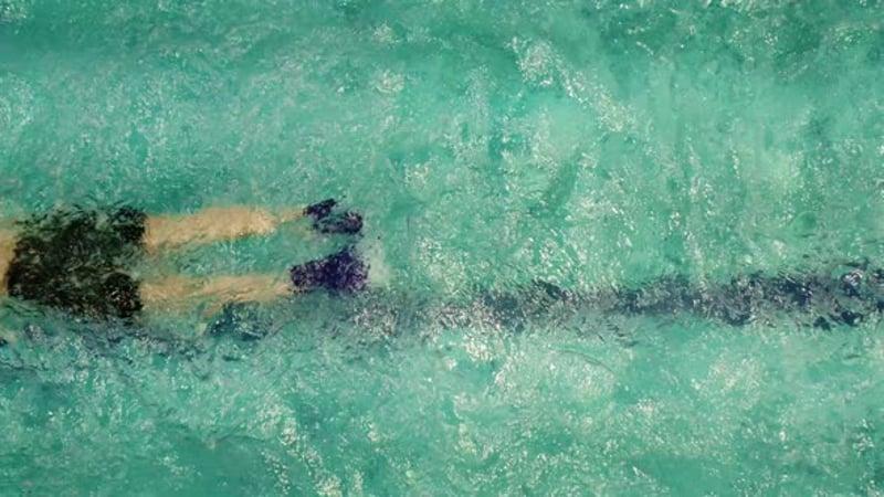 Aerial View of a Swimmer in Turquoise Waters
